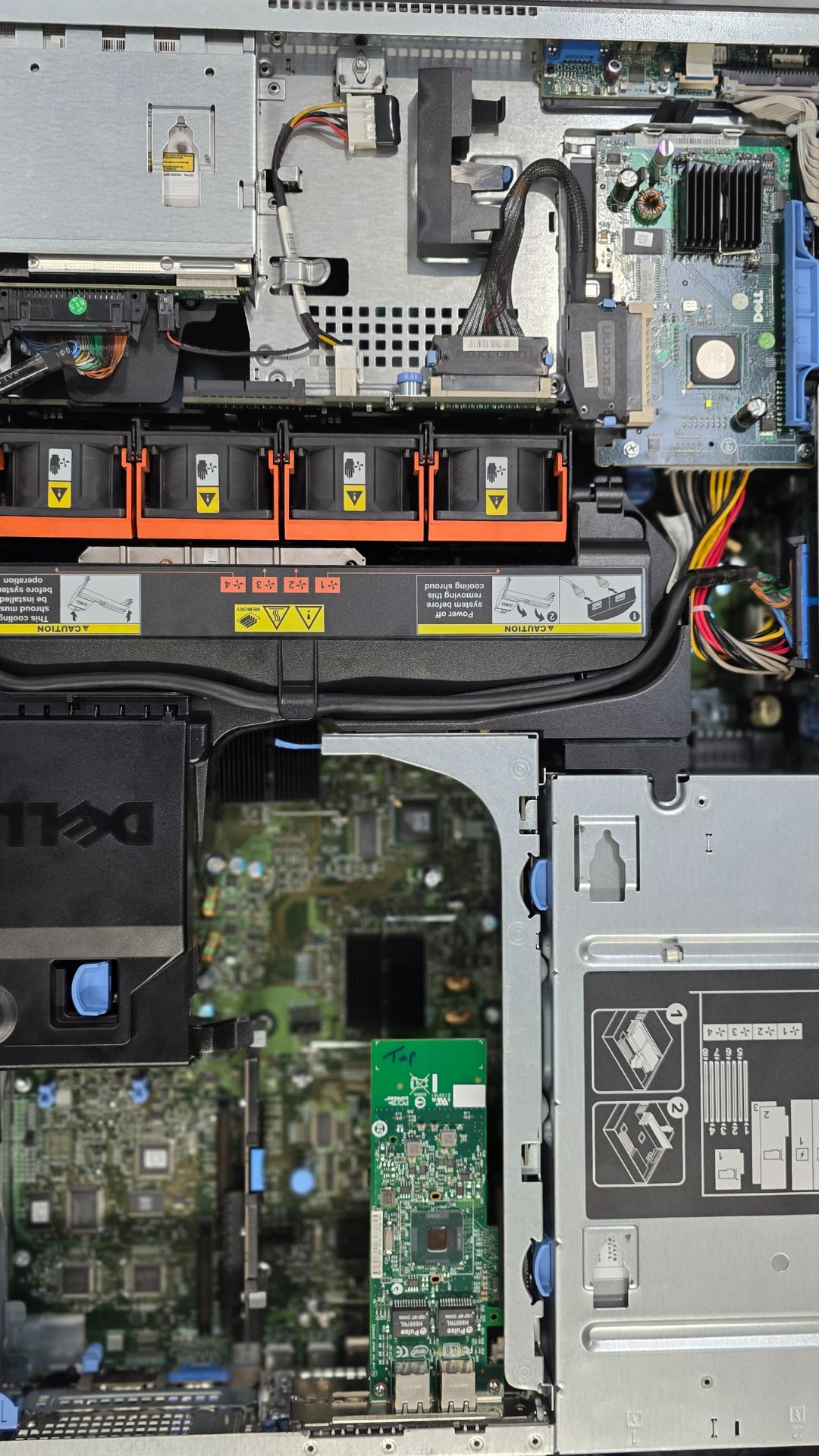 Industrial electronic and automation repair of a Dell server, featuring exposed circuit boards, wiring, cooling systems, and internal components arranged for diagnostic and maintenance work.
