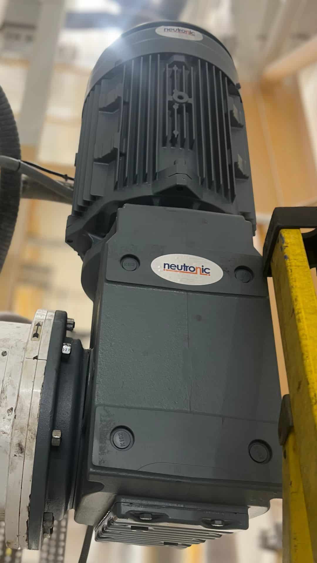 Industrial parts supply – close-up of a Neutronic gear motor used in heavy-duty machinery and automation systems, showcasing durable design and precision engineering.