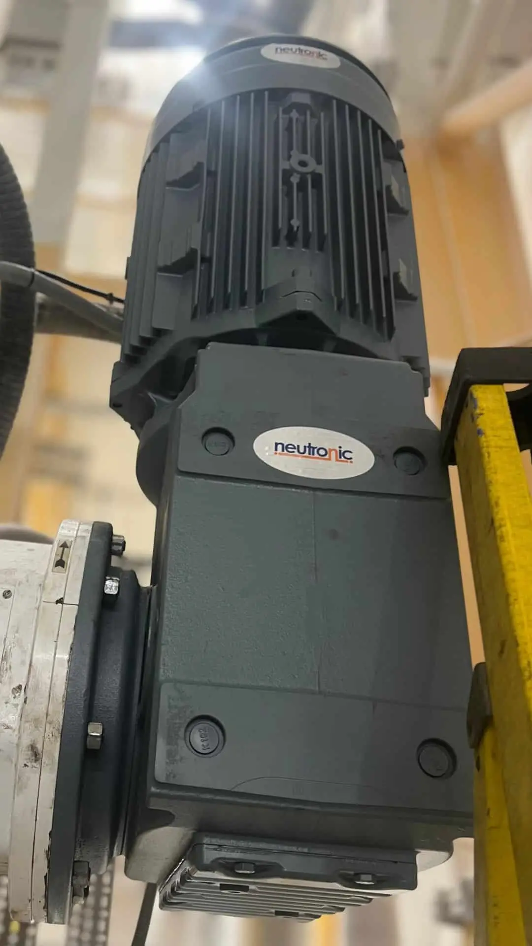 Industrial parts supply – close-up of a Neutronic gear motor used in heavy-duty machinery and automation systems, showcasing durable design and precision engineering.