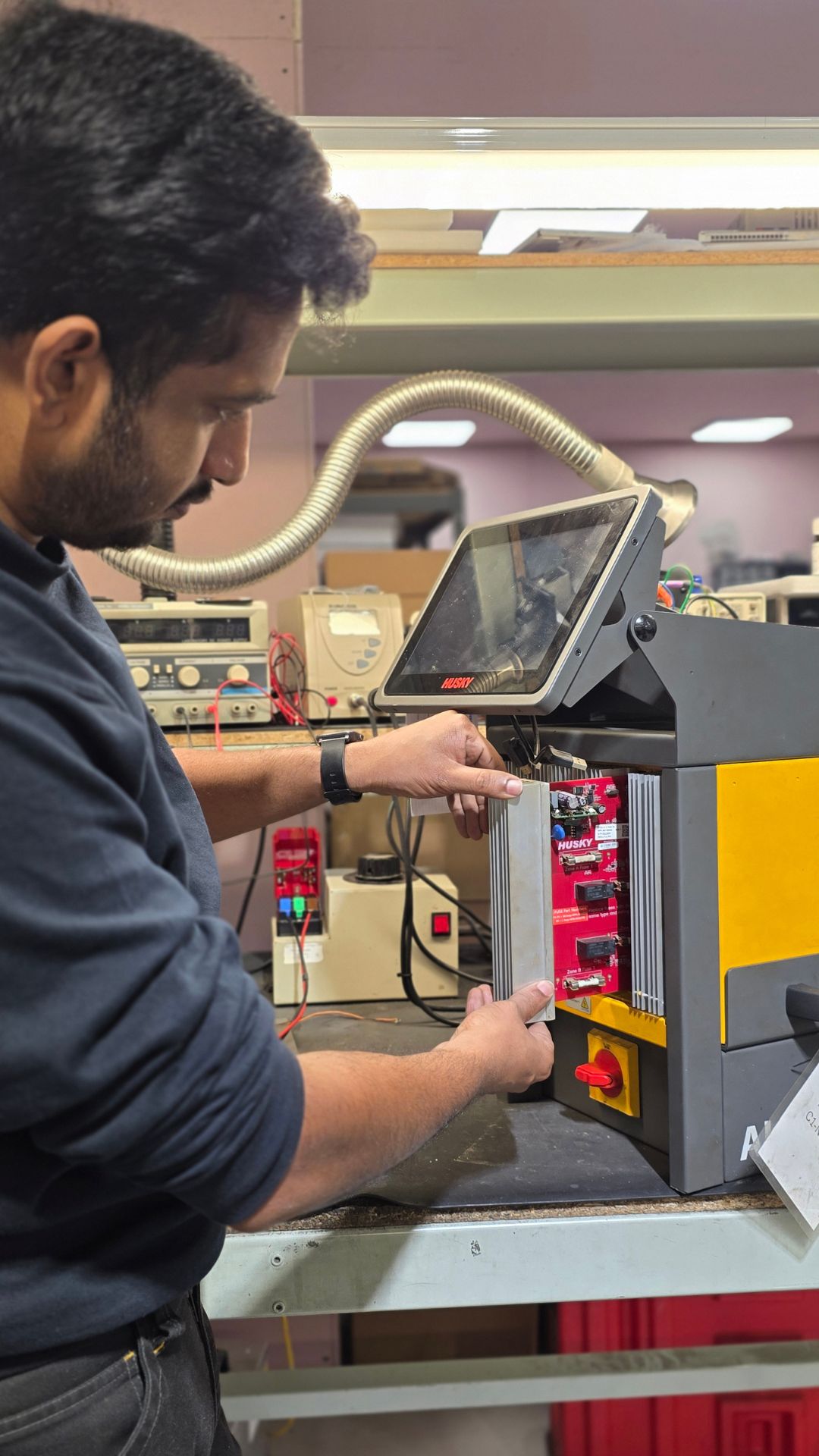 Industrial controller repairs are in progress with a Neutronic Technologies engineer installing and testing an industrial controller module on a dedicated repair station.
