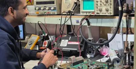 A neutronic engineer performing automation maintenance and diagnostics on electronic control systems in Neutronic UK distribution centre repair workshop