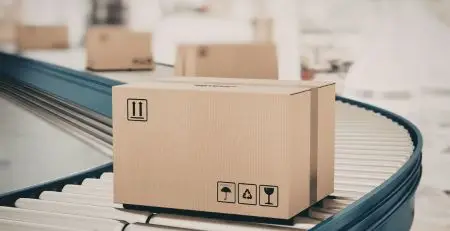 A box moving on conveyor belt system in a warehouse showing distribution centre automation conveyor system operations and logistics handling