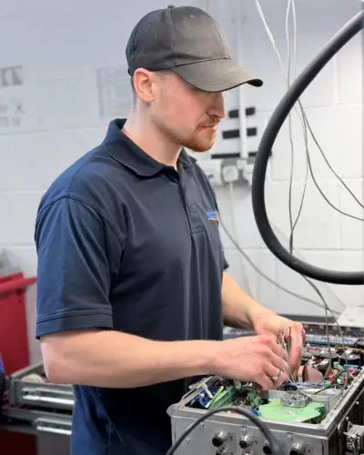 LJU Automation repair engineer at Neutronic Technologies carrying out advanced diagnostics and electronic testing on industrial LJU automation control equipment in the UK repair workshop.